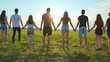 © Довидович Михаил - Cohesion concept. A group of friends are holding hands at sunset.