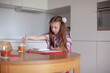 © Юлия Ефимова - 7 years old girl painting with watercolor in the kitchen. Home interior.