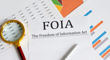 Paper with The Freedom of Information Act FOIA on a table