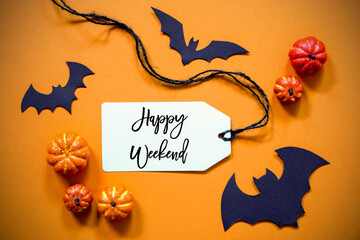 White Label With English Text Happy Weekend. Halloween Decoration Like Bat. Autum Pumpkin Decoration On Orange Background