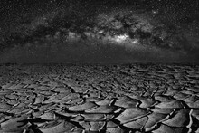 Cracked Dry Land And Universe Space Of Milky Way Galaxy On Night Sky.