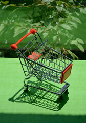 empty shopping cart on green background