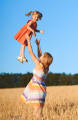 Wall Mural - mother throwing girl in red dress