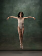 canvas print picture - Growth. Graceful classic ballerina dancing on dark studio background. Pastel bodysuit. The grace, artist, movement, action and motion concept. Looks weightless, flexible. Fashion, style.