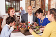 © JackF - Happy family with little boy and mature grandmother having dinner and nice talking at restaurant