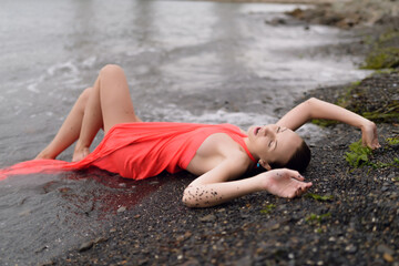 Wall Mural - Beautiful woman in a dress on a beach.