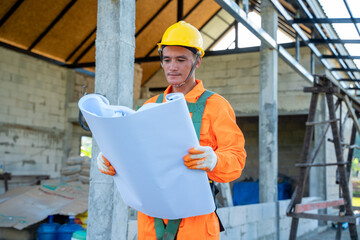 Poster - Engineer at work with blueprints in front of a construction site.