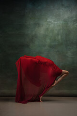 Wall Mural - Character. Graceful classic ballerina dancing on dark studio background. Deep red cloth. The grace, artist, movement, action and motion concept. Looks weightless, flexible. Fashion, style.