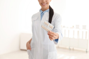 Wall Mural - Professional pharmacist with pills in drugstore, closeup