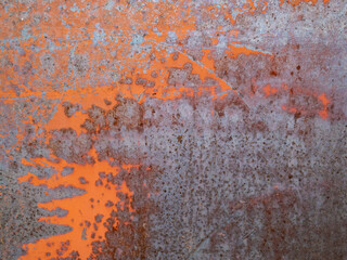 Rusty blue and orange painted detailed metal texture background. Close up view of grunge metal surface.