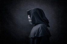 Scary Figure In Hooded Cloak In The Dark