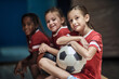 © luckybusiness - Girl with soccer ball  in good mood  before training  in changing room.