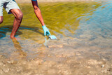 Fototapeta Sport - young man cleaning the river