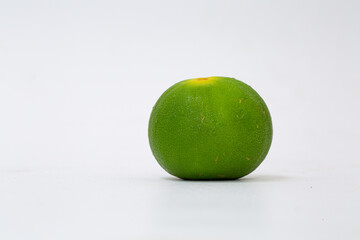 Green lemon on white background