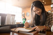 © Chayanon - Happy Smiling Girl Studying And Learning While Using Notebook. Freelance Work, Business People Concept