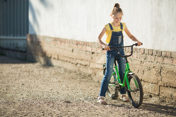 Wall Mural - beautiful teenage girl riding a bicycle in summer