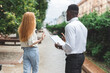 © vladdeep - Obsessive black man in business attire interview on the street bothering passersby with questions