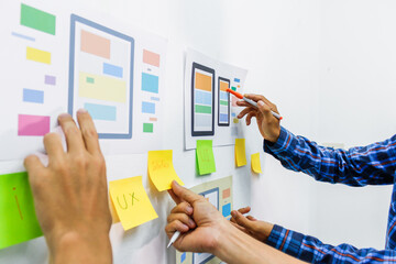 the team of website designers with the ux ui system are writing programs and laying the layer to det
