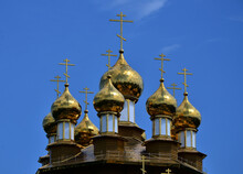 Golden Domes Of An Orthodox Church Against A Bright Blue Sky