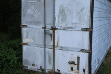 White tractor-trailer parked with door close-up.