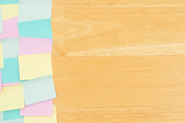 Canvas Print - Sticky note background with multi-color notes on a wood desk