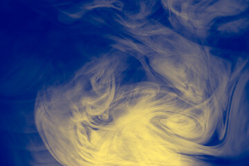 Wall Mural - clouds of colored flowing smoke on a dark background.