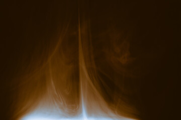 Wall Mural - clouds of colored flowing smoke on a dark background.