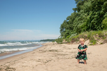 Wall Mural - Little girl standing on the beach at Indian Dunes National Park posing for a picture