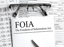 Paper with text FOIA The Freedom of Information Act on a table