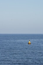 View Of Yellow Buoy In The Middle Of Calm Blue Sea