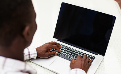 empty computer screen template with hands of african man