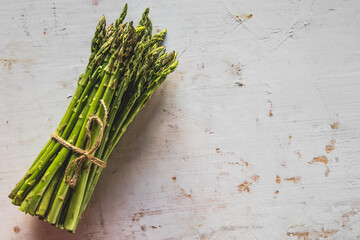 Fresh green spring asparagus on a wooden background. Asparagus season