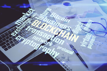 Double exposure of blockchain and crypto economy theme hologram and table with computer background. Concept of bitcoin cryptocurrency.