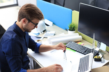 Shot of a handsome male architect working on a design in his office.