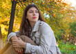 © papa - Portrait of a beautiful young woman on the background of autumn leaves.
