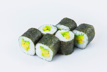Side View Of Vegetarian Japanese Maki Roll With Avocado And Rice Wrapped In Nori Seaweed. Close-up Of Asian Traditional Vegan Dish Isolated On Gray Background. Isolation Menu Image
