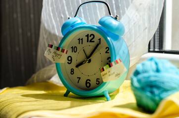 bright blue alarm clock on the windowsill