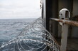 Barbed wire attached to the ship hull, superstructure and railings to protect the crew against piracy attack in the Gulf of Guinea in West Africa. 