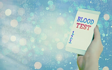 Text sign showing Blood Test. Business photo text Extracted blood sample from an organism to perfom a laboratory analysis Modern gadgets with white display screen under colorful bokeh background