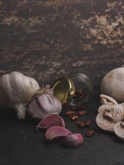 Sticker - Vertical closeup shot of mushrooms, garlic, and cayenne pepper with a rustic wooden background