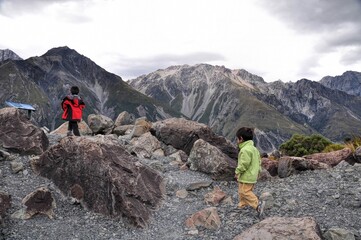 two asian boys go hiking in mount cook, new zealand