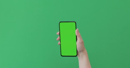 Sticker - Young female hand show smartphone with green screen on green background