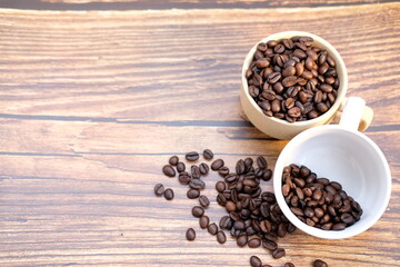 Poster - Top view coffee cup and coffee beans on wood table, space for text