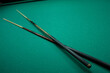 © IHOR - two pool cues on the table
