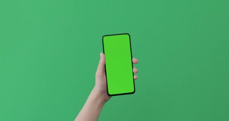 Sticker - Young female hand touch smartphone with green screen on green background