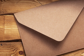 Wall Mural - old cardboard postal envelope at wooden background