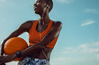 © Jacob Lund - Sportswoman standing outdoors holding a basketball