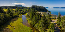 Aerial View Of A Watershed On Lummi Island, Washington. Drone Shot Of A Slough That Lies Adjacent To Legoe Bay On An Island In The Northwest Corner Of Washington State. 