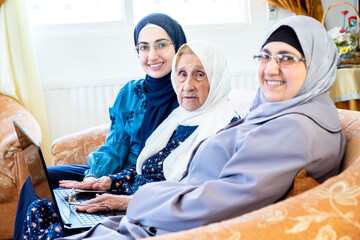 Wall Mural - Happy arabic muslim grandmother and grand daughter and mother si