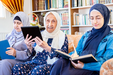 Happy arabic muslim grandmother and grand daughter and mother si